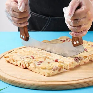 Stainless steel curved kitchen knife with wooden handles for cutting sweet nougat.