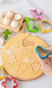 Stainless steel cookie cutter set with colorful plastic edge for baking pastries and biscuits.