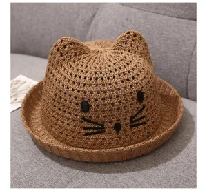 Cute straw hat for babies and toddlers in summer, brown knitted design with sweet cat ears.