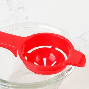 Red plastic egg white separator kitchen tool with bowl clip for easy baking and cooking use.