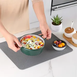 Silicone kitchen drying mat with ribbed drainage design, non-slip heat-resistant counter mat.