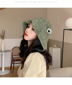 Green crocheted bucket hat detail, summer sun protection straw hat with cute flower accent.