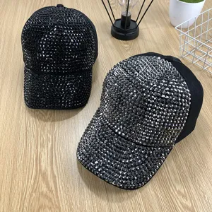 Detailed close-up view of sparkling rhinestone baseball caps showing exquisite crystal textures.