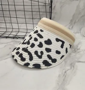 Summer cow print straw visor hat, empty top headband design, breathable sun protection accessory.