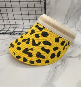 Detailed view of yellow cow print straw visor showing fine texture and summer style.