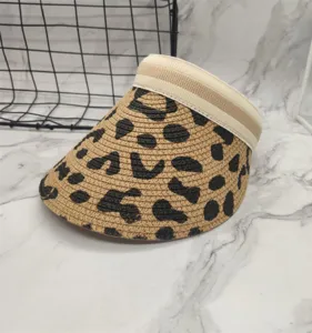 Leopard print straw sun visor hat detail, woven texture, comfortable wide brim for summer.