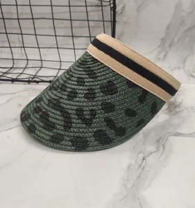 Summer woven empty top sun visor hat with cow print pattern and striped elastic band.