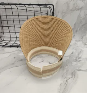 Detail shot of summer hollow top straw sun visor hat with striped inner band and wide brim.