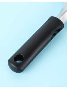 Close-up detail of the black plastic handle on a stainless steel ice cream scoop utensil.