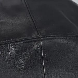 Close-up detail shot of black PU leather beret displaying exquisite fine stitching texture.