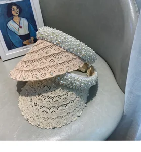 Detailed shot of elegant women's pearl lace empty-top sun hat, perfect for summer vacation.
