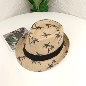 Vue détaillée d'un chapeau de paille beige avec ruban noir et motif de palmiers.