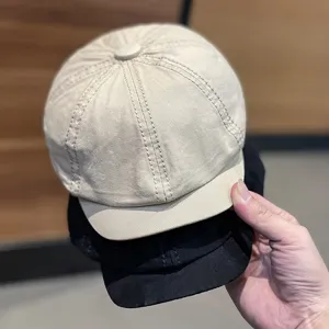Close-up of classic newsboy cap in beige and black, detailed stitching, fashion retro berets