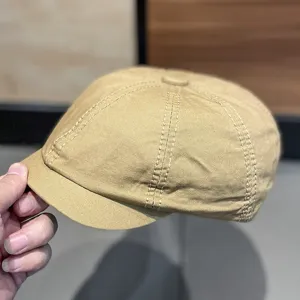 Detailed view of the khaki cotton newsboy cap showing fine stitching and classic retro style.