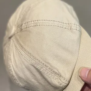 Detailed view of khaki octagonal beret cap, showcasing fine stitching and fabric texture.