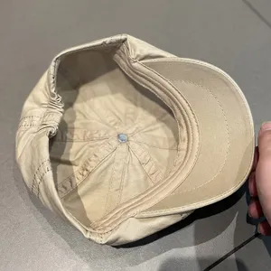 Interior detail view of a classic beige retro octagonal beret hat showing neat lining and fit.