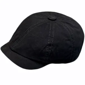 Black retro octagonal newsboy hat detail, classic stitched panel design for vintage fashion style.