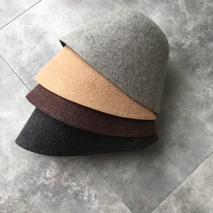 Stacked wool bucket hat detail showing multiple color options in winter style close up view.