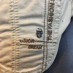 Detailed view of the casual khaki beret featuring metal skull decor and stylish embroidery.
