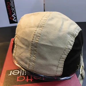 Detailed view of casual canvas flat cap with multi-panel stitching for outdoor wear.