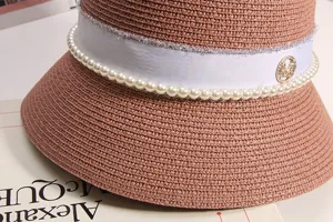 Stiloso cappello di paglia estivo da donna con perle, strass e logo M alla moda.