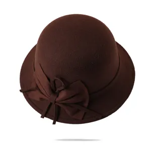 Detailed view of women's vintage felt bowler hat in brown with a bow accent for autumn.
