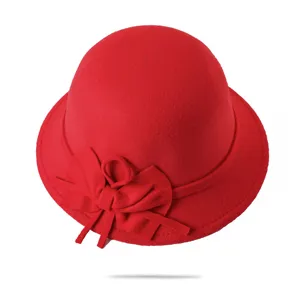 Red felt cloche hat detail view, stylish wool bow decoration for women, winter fashion accessory.