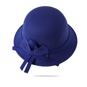 Close-up detail of a dark blue women wool felt cloche hat with a sweet bow decoration.
