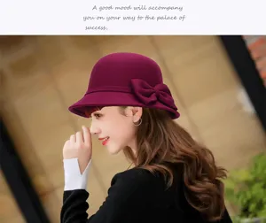 Close-up detail of the elegant women's burgundy wool cloche hat with a stylish side bow.