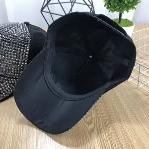 Black rhinestone baseball cap for women, stylish adjustable sun hat with breathable lining.