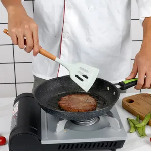 Silicone slotted spatula with wooden handle for kitchen cooking, non-stick cookware friendly.