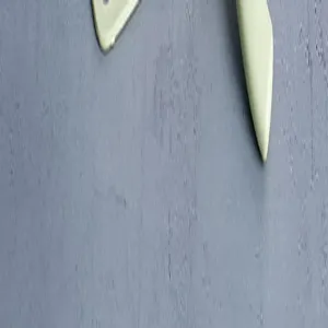 Detailed view of the ergonomic handle and sharp blade of the mini ceramic fruit knife.