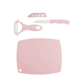 Pink ceramic fruit knife set with peeler and cutting board, ideal for home kitchen and office use.