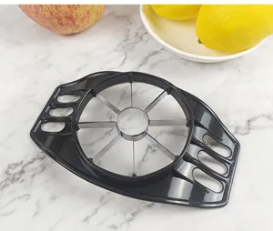 Stainless steel apple slicer detail, fruit cutter and core remover tool with plastic handle.