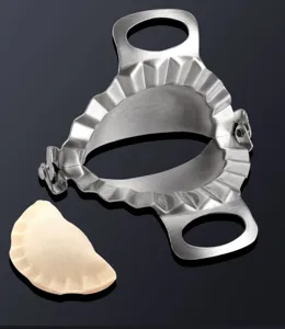 Stainless steel dumpling maker kitchen tool for easy manual dumpling shaping and making.