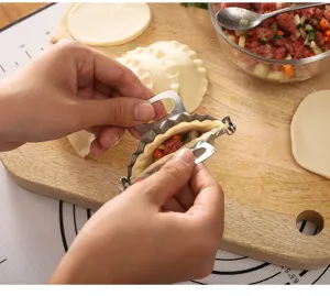Stainless steel dumpling maker mold manual kitchen pastry tool for easy dumpling folding.