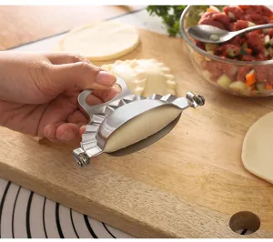Stainless steel dumpling maker detail view, kitchen tool for easy homemade dumplings close-up