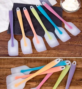 Translucent silicone spatula detail, colorful baking and cake scraper tool for kitchen cooking.