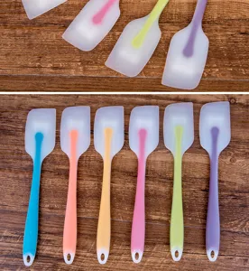 Translucent silicone spatula baking tool detail shot, flexible cake scraper for kitchen.