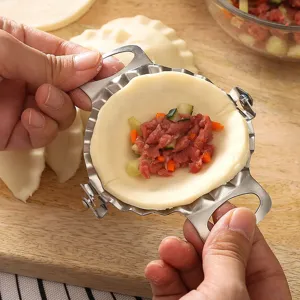 Stainless steel dumpling maker mold press tool for easy home kitchen handmade wrapper folding.