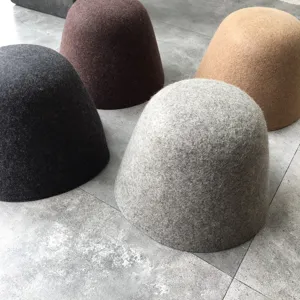 Detail view of minimalist wool felt bucket hats in four colors, perfect for autumn winter.