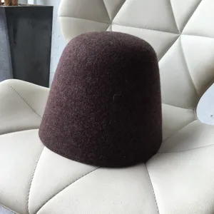 Close-up detail view of the dark brown wool felt bucket hat showcasing soft texture.