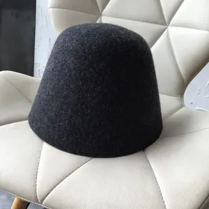 Dark grey wool felt bell hat detail, minimalist winter bucket hat showing fine texture and shape.