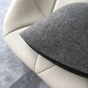 Close-up detail of dark gray wool felt bucket hat showcasing fine texture and neat stitching.