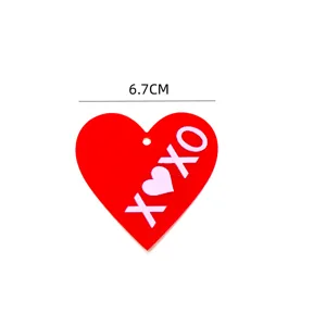 Valentine's Day red acrylic heart cake topper with XOXO print, perfect cupcake decor.