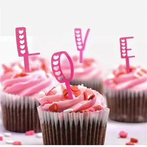 Pink acrylic LOVE cupcake toppers with heart cutouts, perfect for Valentine's Day.