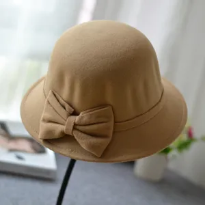 Close-up detail of the elegant camel felt dome hat featuring a stylish side bow design.