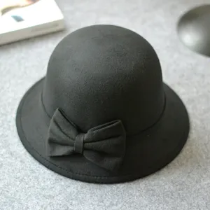 Black felt cloche hat with a chic bow detail, elegant winter headwear accessory close-up.