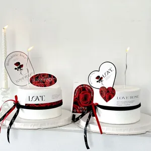 Valentine's Day cake decoration set with romantic rose cards, paper toppers, and ribbons.