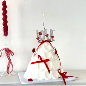 Exquisite rhinestone LOVE cake topper with candle and red bows for Valentine's Day party.